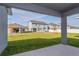 Spacious backyard with grassy area and covered patio at 437 Silver Palm Dr, Haines City, FL 33844