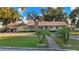 Single-story home with stone accents and a spacious lawn at 1241 W Lakeshore Dr, Clermont, FL 34711