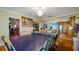 Unique dining room with a ping pong table and view into the kitchen at 1241 W Lakeshore Dr, Clermont, FL 34711