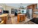 Open kitchen boasts a center island, wood cabinets, and stainless steel appliances at 1241 W Lakeshore Dr, Clermont, FL 34711