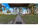 Brick paved pathway to a lakefront patio with firepit at 1241 W Lakeshore Dr, Clermont, FL 34711