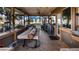 Large covered patio with lake views, wooden deck, and outdoor seating at 1241 W Lakeshore Dr, Clermont, FL 34711