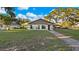 Lakefront home with large windows reflecting the water view at 1241 W Lakeshore Dr, Clermont, FL 34711
