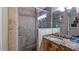 Walk-in shower with granite vanity and tile at 1241 W Lakeshore Dr, Clermont, FL 34711