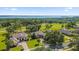 Aerial view of luxurious home and golf course at 5418 Meadow Hill Loop, Lady Lake, FL 32159