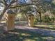 Elegant entrance gate with stone pillars and metal at 13524 Corkwood Ln, Astatula, FL 34705