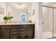 Bathroom with granite countertop, dark brown vanity, and walk-in shower at 2226 Lelani Cir, Davenport, FL 33897