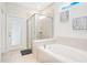Bathroom with soaking tub, walk-in shower, and private access at 2226 Lelani Cir, Davenport, FL 33897