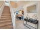 Bright and spacious entryway with staircase and view to kitchen at 2226 Lelani Cir, Davenport, FL 33897