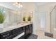 Double vanity bathroom with granite countertop and walk-in shower at 2226 Lelani Cir, Davenport, FL 33897