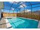 Relaxing screened pool and spa with a spacious patio area at 2226 Lelani Cir, Davenport, FL 33897
