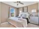 King-size bed, large window, and a dresser with lamp at 2226 Lelani Cir, Davenport, FL 33897