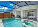 Screened pool and spa with patio furniture and grill at 2226 Lelani Cir, Davenport, FL 33897