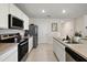 Modern kitchen with stainless steel appliances and island at 2720 Dumont Ln, Tavares, FL 32778