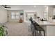 Spacious living room with carpeted floors and kitchen island at 2720 Dumont Ln, Tavares, FL 32778