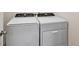 Laundry room with side-by-side Whirlpool washer and dryer at 2720 Dumont Ln, Tavares, FL 32778