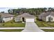 Single story home with two-car garage and landscaped yard at 2720 Dumont Ln, Tavares, FL 32778