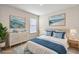Virtually staged bedroom with coastal decor and a comfy bed at 2720 Dumont Ln, Tavares, FL 32778