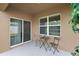 Covered patio with a small table and chairs, offering a peaceful outdoor space at 2720 Dumont Ln, Tavares, FL 32778