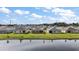 Community of homes situated along a calm lake, showcasing a picturesque setting at 2720 Dumont Ln, Tavares, FL 32778