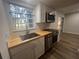 Modern kitchen with butcher block countertops and stainless steel appliances at 7874 Midway Drive Ter # V101, Ocala, FL 34472