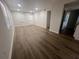 Bright living room featuring wood-look floors and access to other rooms at 7874 Midway Drive Ter # V101, Ocala, FL 34472