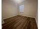 Simple bedroom with wood-look floors and window coverings at 7874 Midway Drive Ter # V101, Ocala, FL 34472