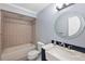 Updated bathroom with tile shower/tub combo, vanity with marble top, and a large mirror at 21342 S Buckhill Rd, Clermont, FL 34715