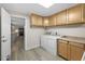 Laundry room with washer/dryer hookups, cabinets, and kitchen views at 21342 S Buckhill Rd, Clermont, FL 34715