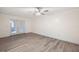 Simple bedroom with hardwood floors, ceiling fan and access to patio at 21342 S Buckhill Rd, Clermont, FL 34715