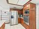 Stainless steel appliances and wood cabinets in this kitchen at 14850 Se 73Rd Ave, Summerfield, FL 34491
