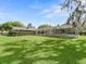 Large backyard with a screened pool and lush green grass at 14850 Se 73Rd Ave, Summerfield, FL 34491