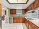 Kitchen features wood cabinets, granite countertops and a tile backsplash at 14850 Se 73Rd Ave, Summerfield, FL 34491