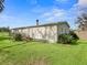 Mobile home with a wooden ramp and tropical plants at 14850 Se 73Rd Ave, Summerfield, FL 34491