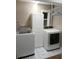 Laundry room with washer, dryer, and storage cabinet at 1501 N Cr 19A, Eustis, FL 32726