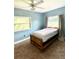 Bright bedroom featuring a twin bed and window with curtains at 1501 N Cr 19A, Eustis, FL 32726