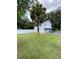 Single story home with fenced yard and palm tree at 1501 N Cr 19A, Eustis, FL 32726