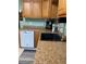 Kitchen with wood cabinets, a black sink, and dishwasher at 1501 N Cr 19A, Eustis, FL 32726