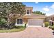 Two story home with brick driveway and lush landscaping at 26142 Avenida Las Colinas # 2B, Howey In The Hills, FL 34737