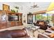 Comfortable living room featuring leather sofas and a large entertainment center at 26142 Avenida Las Colinas # 2B, Howey In The Hills, FL 34737