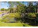 Gated community entrance with palm trees and lush landscaping at 26142 Avenida Las Colinas # 2B, Howey In The Hills, FL 34737