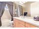 Bathroom with tub, toilet, and light wood vanity at 26142 Avenida Las Colinas # 2B, Howey In The Hills, FL 34737