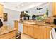 Open kitchen boasts granite counters, light wood cabinets, and views into adjacent living areas at 26142 Avenida Las Colinas # 2B, Howey In The Hills, FL 34737