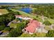 Large clubhouse with red tile roof, situated near a golf course at 26142 Avenida Las Colinas # 2B, Howey In The Hills, FL 34737