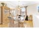 Formal dining room featuring hardwood floors, a glass-top table, and a chandelier at 26142 Avenida Las Colinas # 2B, Howey In The Hills, FL 34737
