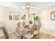 Bright dining room features a glass table with four chairs and a chandelier at 26142 Avenida Las Colinas # 2B, Howey In The Hills, FL 34737