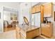 Kitchen features granite counters, wood cabinets, and a breakfast bar at 26142 Avenida Las Colinas # 2B, Howey In The Hills, FL 34737