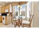 Bright kitchen nook with glass-top table and wicker chairs near a window at 26142 Avenida Las Colinas # 2B, Howey In The Hills, FL 34737