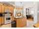 Island kitchen with wood cabinets, granite counters, and a breakfast nook at 26142 Avenida Las Colinas # 2B, Howey In The Hills, FL 34737