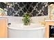 Round soaking tub in a corner bathroom with decorative wallpaper at 26142 Avenida Las Colinas # 2B, Howey In The Hills, FL 34737